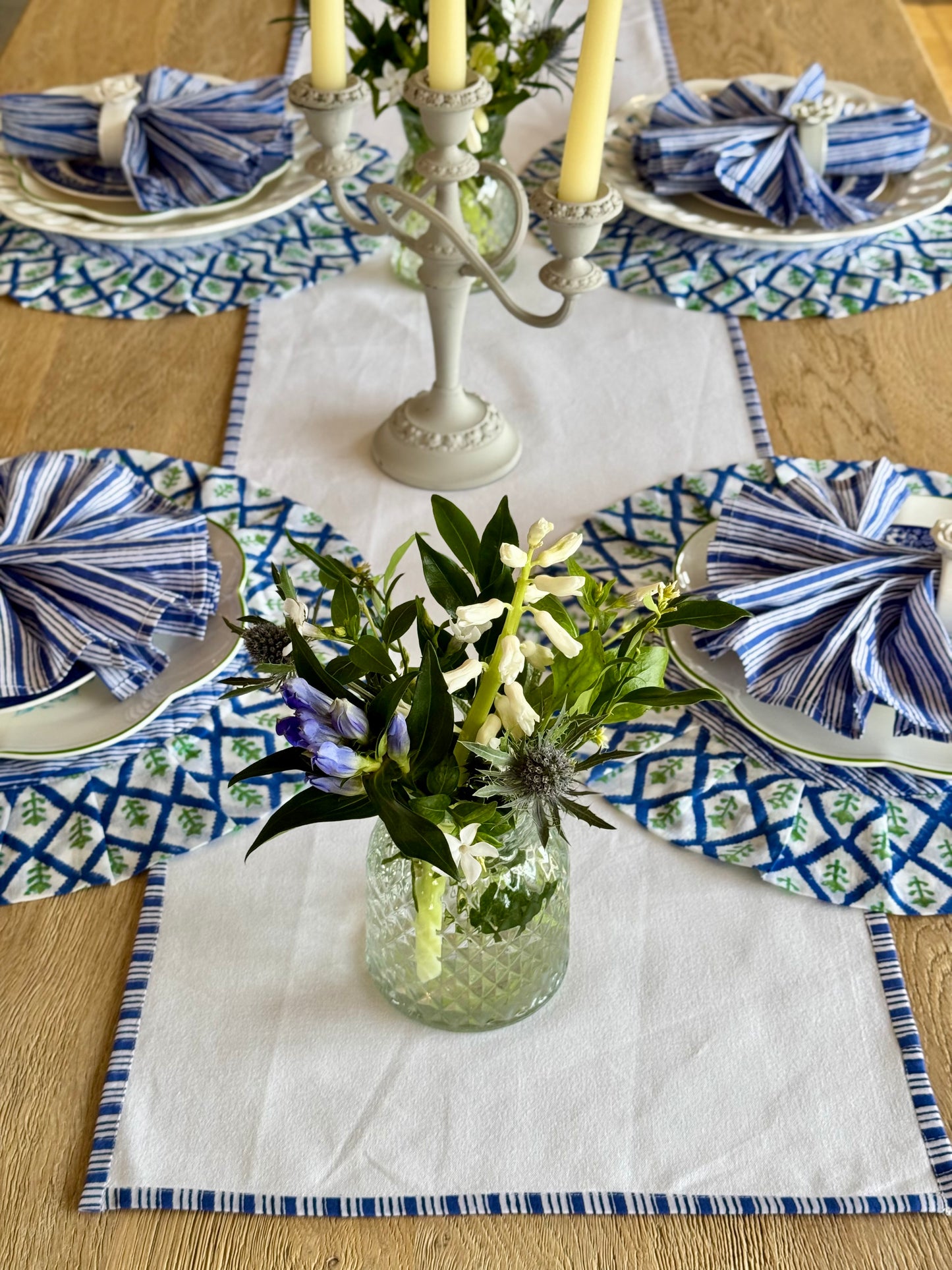 White table runner with a delicate blue striped edge detail